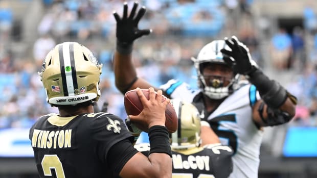 New Orleans Saints quarterback Jameis Winston looks to pass as Carolina Panthers defensive tackle Derrick Brown pressures