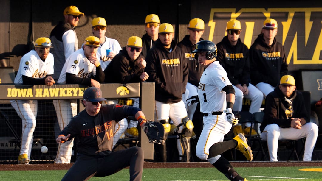 Iowa’s Caleb Wulf (1) hustles down the first base line as the ball get’s past Illinois’ AJ Putty (14) May 1, 2026 during a Big Ten baseball game at Duane Banks Field in Iowa City, Iowa.