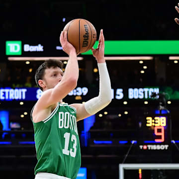 Dec 12, 2024; Boston, Massachusetts, USA; Boston Celtics forward Drew Peterson (13) shoots over Detroit Pistons forward Paul Reed (7) during the second half at TD Garden. Mandatory Credit: Eric Canha-Imagn Images