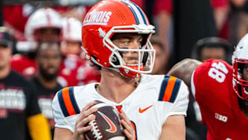 Sep 20, 2024; Lincoln, Nebraska, USA; Illinois Fighting Illini quarterback Luke Altmyer (9) drops to throw against Nebraska Cornhuskers linebacker MJ Sherman (48) during the first quarter at Memorial Stadium. Mandatory Credit: Dylan Widger-Imagn Images