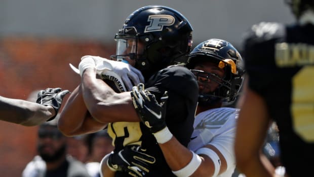 Purdue Boilermakers wide receiver Jaron Tibbs (13) is tackled by Purdue Boilermakers defensive back Salim Turner-Muhammad (7)