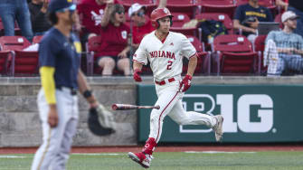 Indiana second baseman Jasen Oliver watches his home run against Michigan.