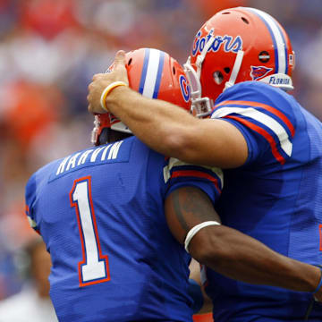 October 25, 2008; Gainesville FL, USA; Florida Gators quarterback Tim Tebow (15) hugs Florida Gators receiver Percy Harvin (1) after he scored a touchdown during the first half against the Kentucky Wildcats at Ben Hill Griffin Stadium. Mandatory Credit: Kim Klement-Imagn Images