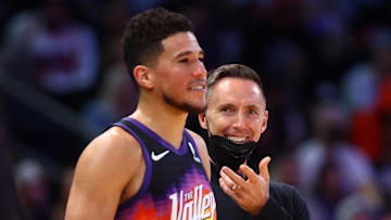 Feb 1, 2022; Phoenix, Arizona, USA; Brooklyn Nets head coach Steve Nash reacts behind guard James Harden (13) and Phoenix Suns guard Devin Booker (1) during the second half at Footprint Center. Mandatory Credit: Mark J. Rebilas-Imagn Images