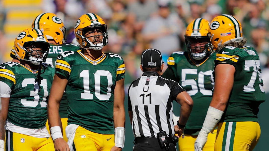 Green Bay Packers quarterback Jordan Love (10) grabs his leg after running the ball against the Minnesota Vikings during their football game Sunday, September 29, 2024, at Lambeau Field in Green Bay, Wisconsin.