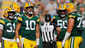 Green Bay Packers quarterback Jordan Love (10) grabs his leg after running the ball against the Minnesota Vikings during their football game Sunday, September 29, 2024, at Lambeau Field in Green Bay, Wisconsin.