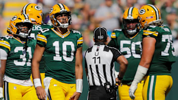 Green Bay Packers quarterback Jordan Love (10) grabs his leg after running the ball against the Minnesota Vikings during their football game Sunday, September 29, 2024, at Lambeau Field in Green Bay, Wisconsin.