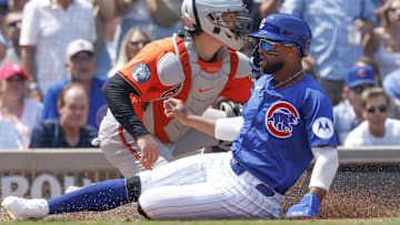 Aug 2, 2025; Chicago, Illinois, USA; Chicago Cubs second baseman Willi Castro (1) wearing number 23 in honor the late Hall of Fame second baseman Ryne Sandberg scores against the Baltimore Orioles during the second inning at Wrigley Field.