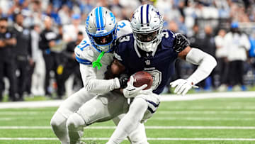 Detroit Lions cornerback Amik Robertson (21) tackles Dallas Cowboys wide receiver George Pickens (3) during the first half at Ford Field in Detroit on Thursday, Dec. 4, 2025.