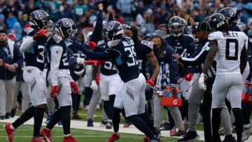 Tennessee Titans cornerback Elijah Molden (24) is mobbed after making a tackle to force a fourth