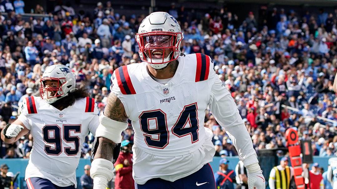 New England Patriots defensive tackle Cory Durden (94) celebrates after linebacker K'Lavon Chaisson (44) ran in a Tennessee Titans fumble during the third quarter at Nissan Stadium in Nashville, Tenn., Sunday, Oct. 19, 2025.