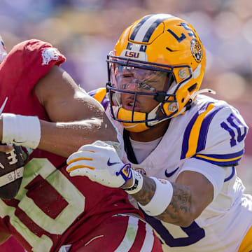 LSU Tigers safety Dashawn Spears (10) sacks Arkansas Razorbacks quarterback Taylen Green (10) during the first half at Tiger Stadium. 