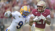 Oct 11, 2025; Tallahassee, Florida, USA; Florida State Seminoles running back Gavin Sawchuk (27) runs the ball past Pittsburgh Panthers linebacker Kyle Louis (9) during the first half at Doak S. Campbell Stadium. Mandatory Credit: Melina Myers-Imagn Images