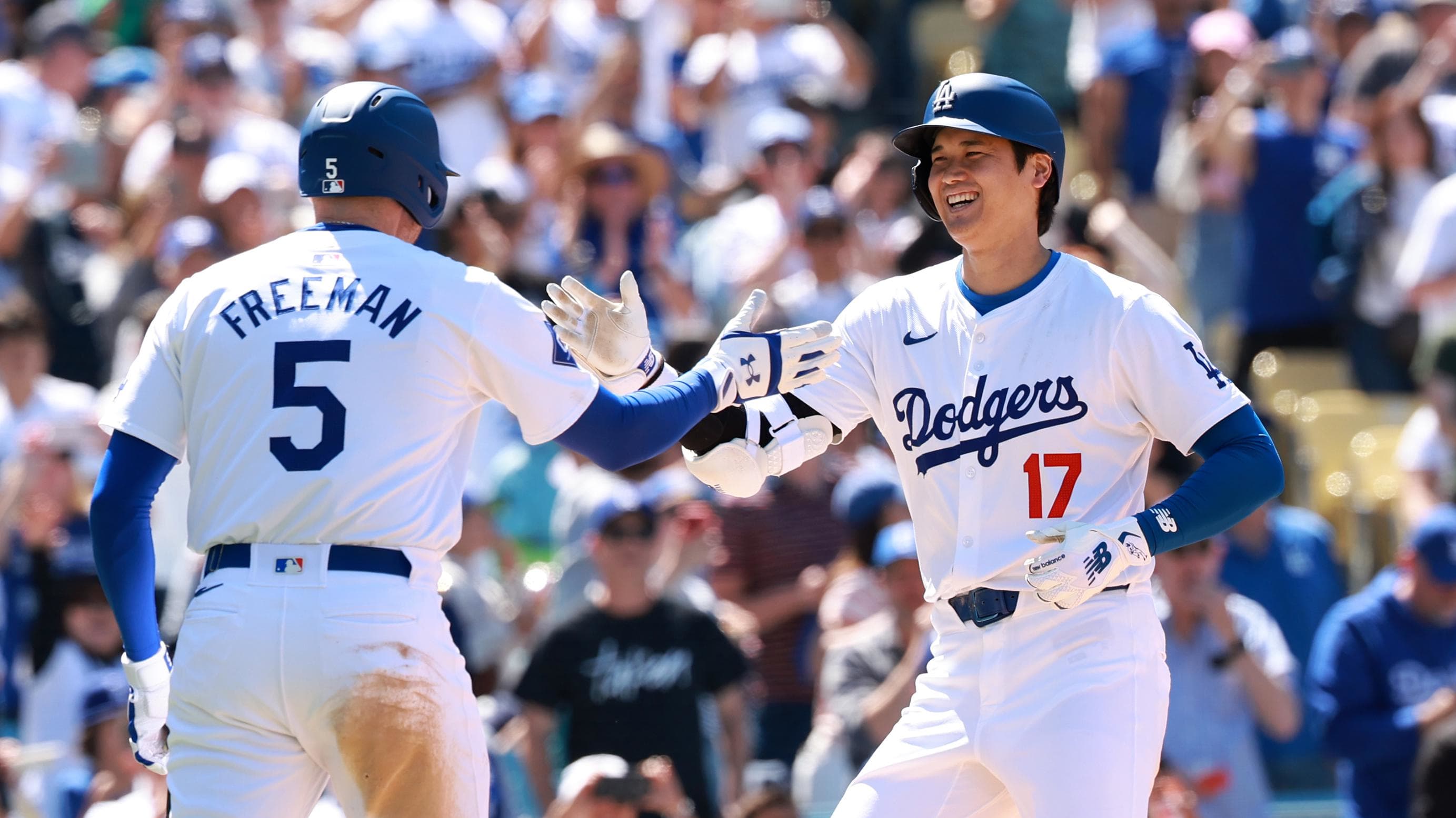Los Angeles Dodgers designated hitter Shohei Ohtani and first baseman Freddie Freeman celebrate while scoring against the Atlanta Braves in Sunday's series finale. 