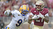 Oct 11, 2025; Tallahassee, Florida, USA; Florida State Seminoles running back Gavin Sawchuk (27) runs the ball past Pittsburgh Panthers linebacker Kyle Louis (9) during the first half at Doak S. Campbell Stadium. Mandatory Credit: Melina Myers-Imagn Images