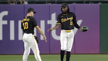 Sep 9, 2024; Pittsburgh, Pennsylvania, USA;  Pittsburgh Pirates left fielder Bryan Reynolds (10) and center fielder Oneil Cruz (15) celebrate after defeating the Miami Marlins at PNC Park. Pittsburgh won 3-2. Mandatory Credit: Charles LeClaire-Imagn Images