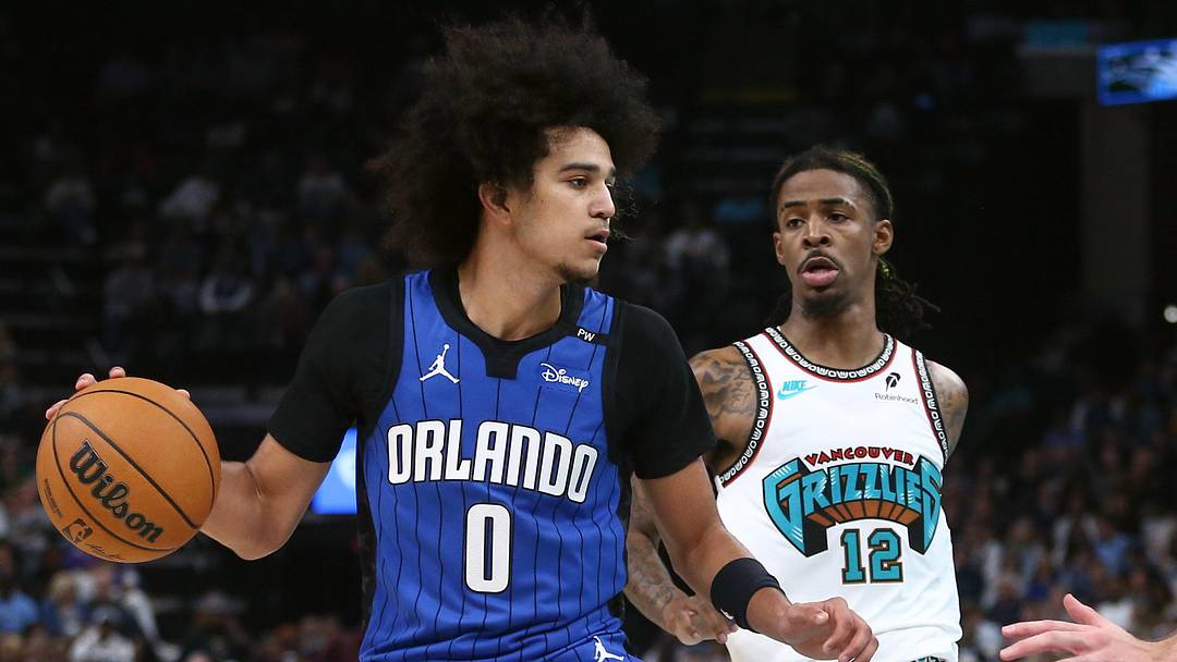 Oct 26, 2024; Memphis, Tennessee, USA; Orlando Magic guard Anthony Black (0) dribbles as Memphis Grizzlies guard Ja Morant (12) defends during the first half at FedExForum. Mandatory Credit: Petre Thomas-Imagn Images