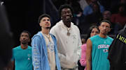Mar 15, 2024; Charlotte, North Carolina, USA; Charlotte Hornets guard LaMelo Ball (1) and center Mark Williams (5) during a time out during the second quarter against the Phoenix Suns at Spectrum Center. Mandatory Credit: Jim Dedmon-Imagn Images