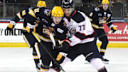 Erie Otters forward Dylan Edwards, leftt, competes against Saginaw Spirit forward Michael Misa during an Ontario Hockey League playoff game at Erie Insurance Arena in Erie on April 1, 2025.