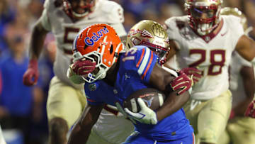 Florida running back Jadan Baugh (13) gets face masked during the second half of an NCAA football game at Steve Spurrier Field at Ben Hill Griffin Stadium in Gainesville, FL on Saturday, November 29, Florida beat Florida State 40-21.2025. [Alan Youngblood/Gainesville Sun]
