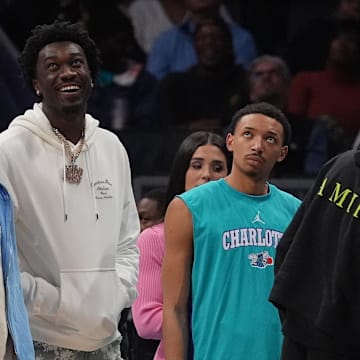 Mar 15, 2024; Charlotte, North Carolina, USA; Charlotte Hornets guard LaMelo Ball (1) and center Mark Williams (5) during a time out during the second quarter against the Phoenix Suns at Spectrum Center. Mandatory Credit: Jim Dedmon-Imagn Images