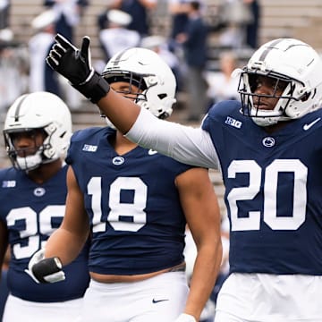 Penn State defensive end Adisa Isaac (20) enters the field with the rest of the defensive unit for team warmups before an NCAA football game against Indiana Saturday, Oct. 28, 2023, in State College, Pa. The Nittany Lions won, 33-24.