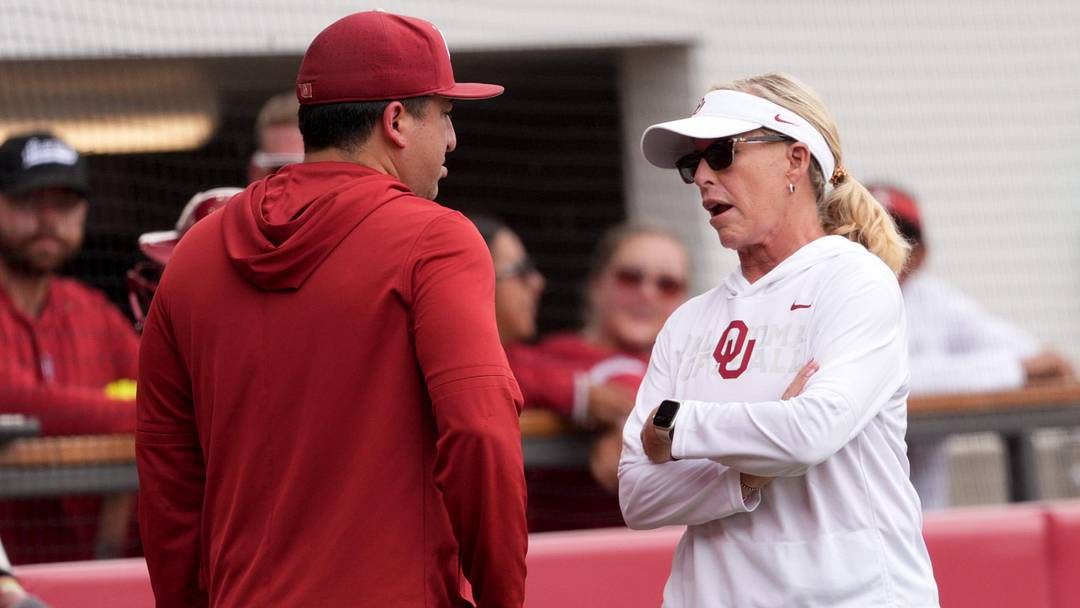 Oklahoma head coach Patty Gasso talks with Associate Head Coach JT Gasso during the NCAA Norman Softball Regional game between the University of Oklahoma Sooners and Michigan Wolverines at Love's Field in Norman, Okla., May, 17, 2026.