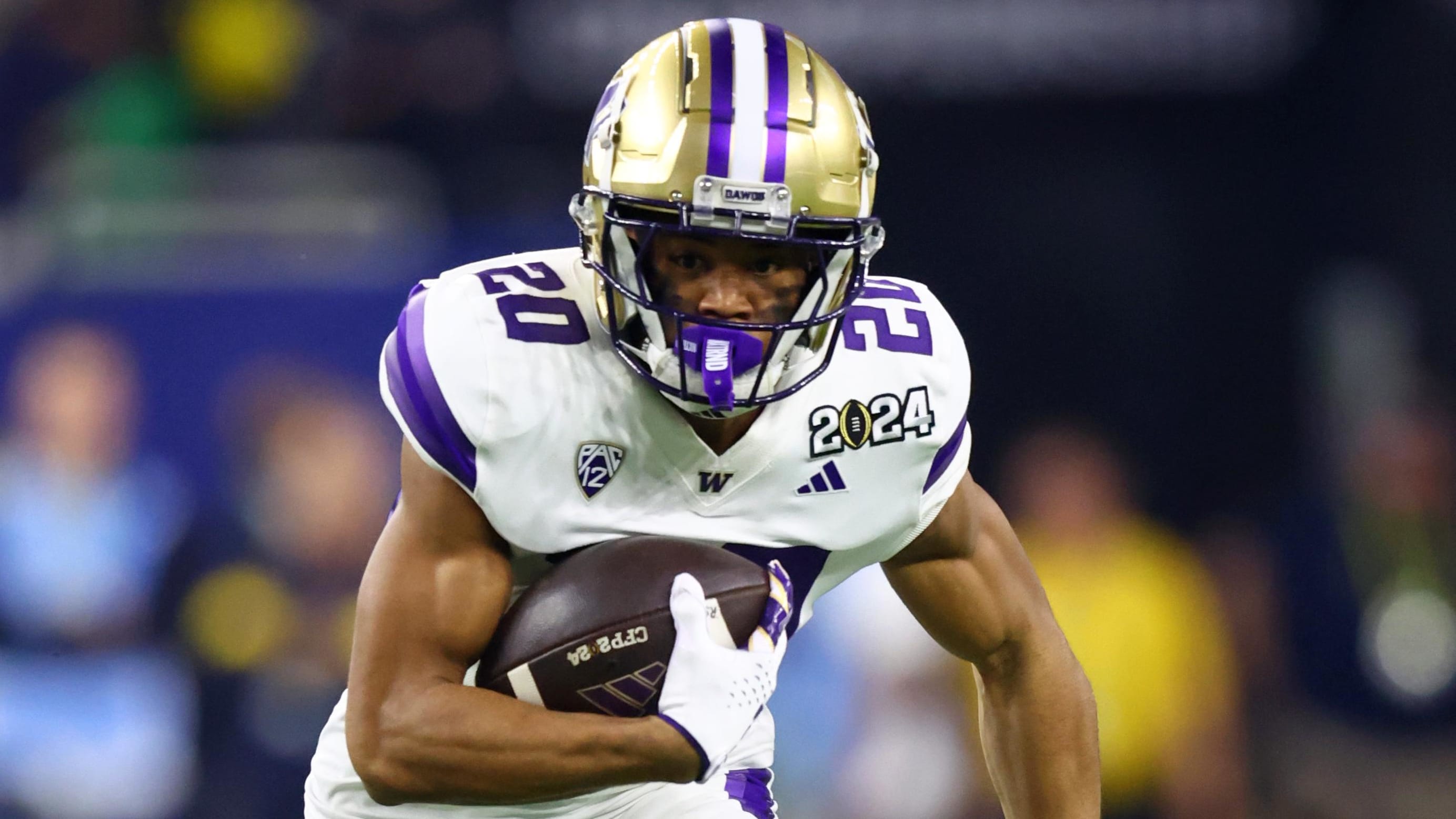 Washington Huskies running back Tybo Rogers on a rushing attempt during a college football game.
