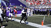Aug 31, 2024; Evanston, Illinois, USA; Northwestern Wildcats head coach David Braun takes the field with his team against the Miami (Oh) Redhawks at Lanny and Sharon Martin Stadium. Mandatory Credit: David Banks-Imagn Images
