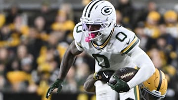 Green Bay Packers wide receiver Matthew Golden is tackled by Pittsburgh Steelers cornerback Darius Slay (23) during the first quarter at Acrisure Stadium.