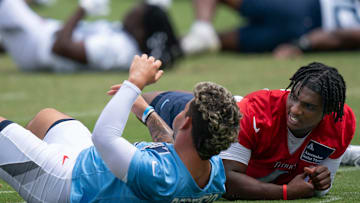 Tennessee Titans Xavier Restrepo, left, and Cam Ward stretch during OTAs at Ascension Saint Thomas Sports Park in Nashville, Tenn., Wednesday, May 28, 2025. The two were former teammates at the University of Miami.