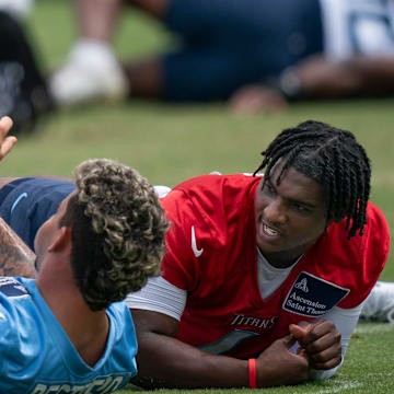 Tennessee Titans Xavier Restrepo, left, and Cam Ward stretch during OTAs at Ascension Saint Thomas Sports Park in Nashville, Tenn., Wednesday, May 28, 2025. The two were former teammates at the University of Miami.