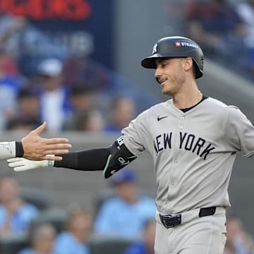 Oct 5, 2025; Toronto, Ontario, CAN; New York Yankees right fielder Aaron Judge (99) congratulates left fielder Cody Bellinger (35) after a two-run home run in the sixth inning against the Toronto Blue Jays during game two of the ALDS round for the 2025 MLB playoffs at Rogers Centre. Mandatory Credit: John E. Sokolowski-Imagn Images
