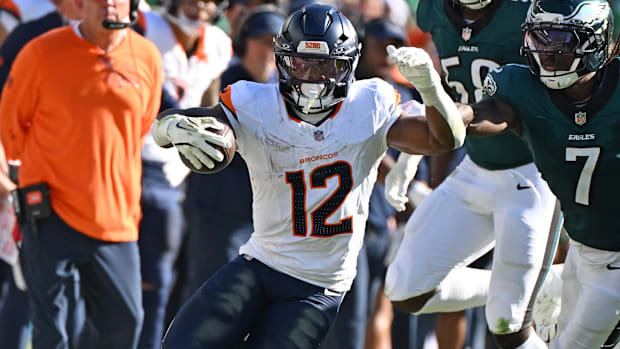 Denver Broncos running back RJ Harvey (12) runs past Philadelphia Eagles cornerback Kelee Ringo (7).