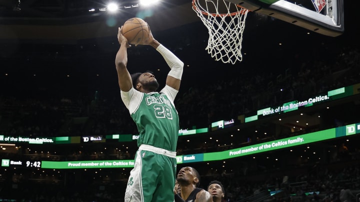 Jan 31, 2022; Boston, Massachusetts, USA; Boston Celtics forward Bruno Fernando (28) grabs a rebound over Miami Heat forward Chris Silva (30) during the second half at TD Garden. Mandatory Credit: Winslow Townson-USA TODAY Sports