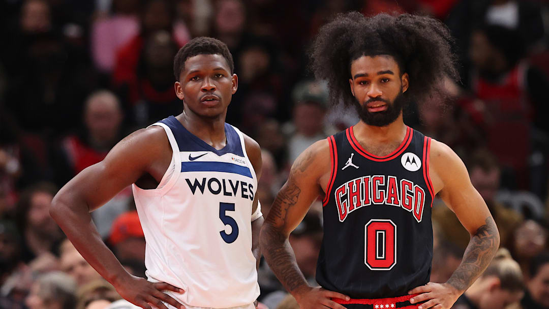 Anthony Edwards of the Minnesota Timberwolves and Chicago Bulls guard Coby White look on during an NBA game.