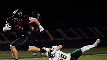 St. Xavier Tigers safety Adam Buehner (8) attempts to tackle Ryle Raiders running back Jacob Savage (21) in the first quarter of a high school football game between the Ryle Raiders and St. Xavier Tigers, Friday, Nov. 15, 2024, at Clifford R. Borland, Sr. Stadium in Union, Ky.