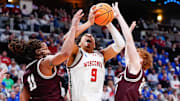 Mar 20, 2025; Montana guards Joe Pridgen (left) and Austin Patterson defend against Wisconsin guard John Tonje during a first-round game in Denver.