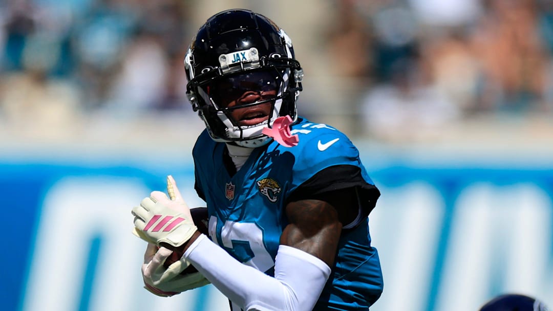 Jacksonville Jaguars wide receiver Travis Hunter (12) rushes for yards against Seattle Seahawks safety Nick Emmanwori (3) during the first quarter of an NFL football matchup, Sunday, Oct. 12, 2025, at EverBank Stadium in Jacksonville, Fla.