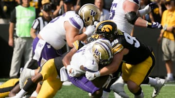 Iowa’s Aaron Graves (95) tackles Washington Washington running back Jonah Coleman (1) Saturday, Oct. 12, 2024 at Kinnick Stadium in Iowa City, Iowa.