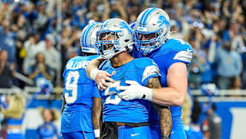 Detroit Lions running back David Montgomery (5) celebrates scoring a touchdown against Los Angeles Rams with center Frank Ragnow (77) during overtime at Ford Field in Detroit on Sunday, September 8, 2024.