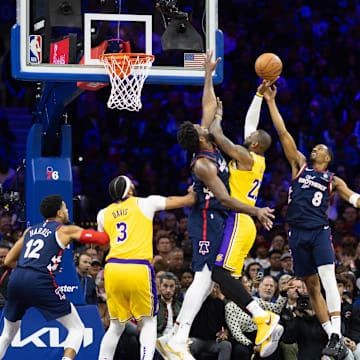 Nov 27, 2023; Philadelphia, Pennsylvania, USA; Philadelphia 76ers center Joel Embiid (21) and guard De'Anthony Melton (8) defend the drive attempt of Los Angeles Lakers forward LeBron James (23) during the third quarter at Wells Fargo Center. Mandatory Credit: Bill Streicher-Imagn Images