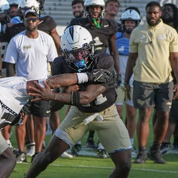 UCF running back Stacy Gage competes with Qua Birdsong during UCF Spring football practice at FBC Mortgage Stadium in Orlando, Friday, April 11, 2025.