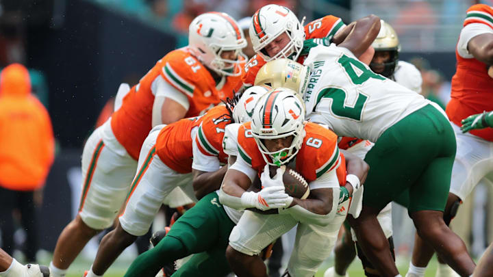 Sep 13, 2025; Miami Gardens, Florida, USA; Miami Hurricanes running back CharMar Brown (6) runs with the football against the South Florida Bulls during the first quarter at Hard Rock Stadium. Mandatory Credit: Sam Navarro-Imagn Images