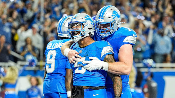 Detroit Lions running back David Montgomery (5) celebrates scoring a touchdown against Los Angeles Rams with center Frank Ragnow (77) during overtime at Ford Field in Detroit on Sunday, September 8, 2024.