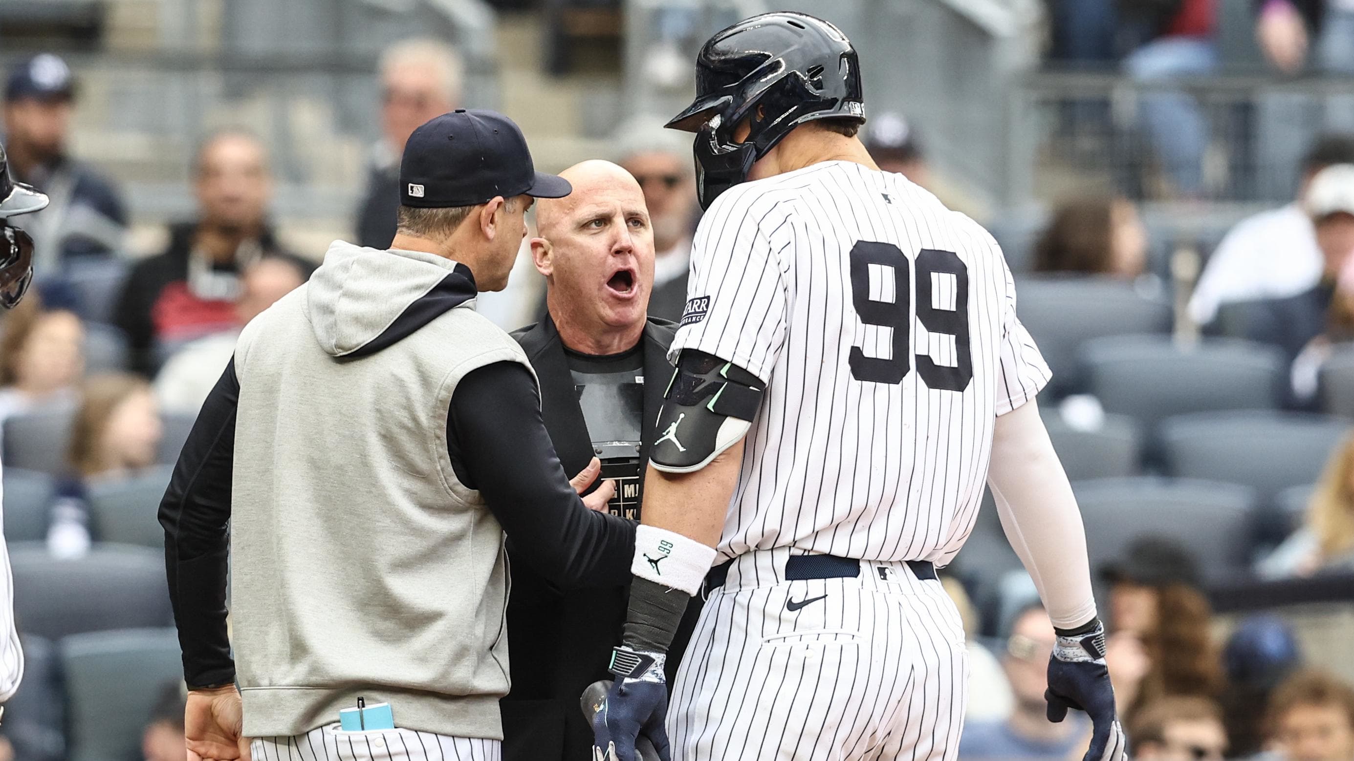 May 4, 2024; Bronx, New York, USA;  New York Yankees OF Aaron Judge (99) and manager Aaron Boone argue with the umpire.