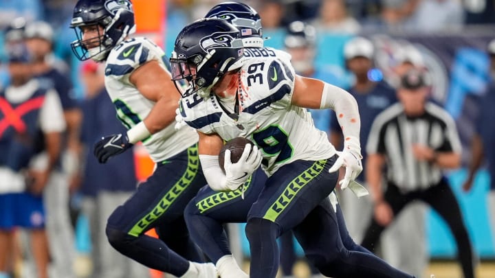 Seattle Seahawks safety Ty Okada (39) runs the ball against the Tennessee Titans during the fourth quarter at Nissan Stadium in Nashville, Tenn., Saturday, Aug. 17, 2024.