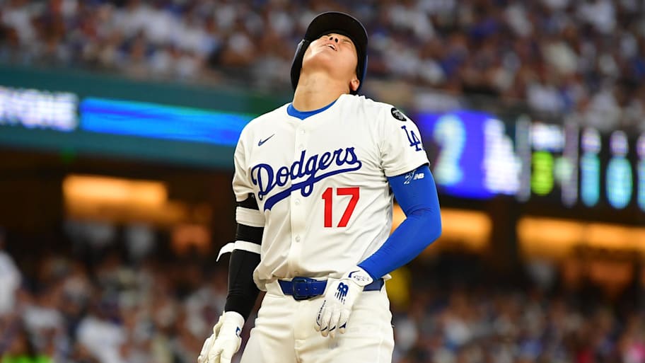 Shohei Ohtani reacts after being hit by a pitch during the third inning against the San Diego Padres. | Gary A. Vasquez-Imagn Images