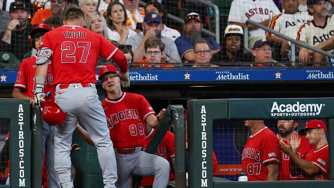 Mar 26, 2026; Houston, Texas, USA; Los Angeles Angels hitting coach Brady Anderson (99) celebrates a home run by right fielder Mike Trout (27) against the Houston Astros in the seventh inning at Daikin Park. Mandatory Credit: Thomas Shea-Imagn Images Mar 26, 2026; Houston, Texas, USA; Los Angeles Angels hitting coach Brady Anderson (99) celebrates a home run by right fielder Mike Trout (27) against the Houston Astros in the seventh inning at Daikin Park. Mandatory Credit: Thomas Shea-Imagn Images