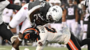 Sep 23, 2023; Pullman, Washington, USA; Washington State Cougars running back Nakia Watson (25) is tackled by Oregon State Beavers defensive back Akili Arnold (0) in the second half at Gesa Field at Martin Stadium. Washington State won 38-35. Mandatory Credit: James Snook-Imagn Images